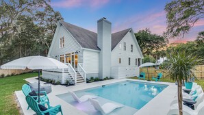 A house with a swimming pool, outdoor seating, and a staircase leading to the entrance. - Private Pool + Fire Pit + Foosball | Short Walk to Beach | Southern Oasis (Isle Of Palms)