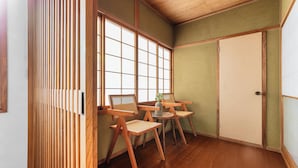 A traditional Japanese room with tatami flooring, sliding doors, and wooden furniture. - THE VILLA SEASIDE (Abashiri)