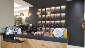 A coffee shop counter with a display of coffee beans and a sign that reads "ARIAN COFFEE." - Arjan Park Hotel Wadi Ad Dawasir (Wadi-Ad-Dawasir)