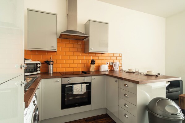 Enjoy cooking in this well-equipped kitchen with an oven, microwave, and ample counter space.