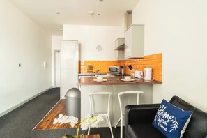 Cozy living space with a kitchenette, bar counter, and comfortable seating area.