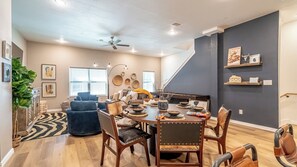 A dining area with a wooden table set for four, surrounded by chairs. - AT&T + Globe Life Walkable | Prime Group Stay (Arlington)