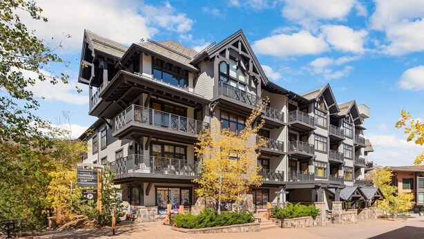 A multi-story hotel with balconies, a stone facade, and a paved courtyard. - Foxtail Flat | Capitol Peak Lodge #3219 | 1B/1B (Snowmass Village)
