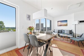 Enjoy meals with family and friends around the large dining table, surrounded by comfortable seating.