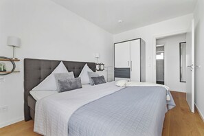 Relax in a spacious room with a large bed, wardrobe, and en-suite amenities.