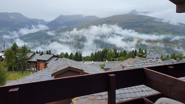 A mountain view with a wooden building in the foreground. - Cozy apartment near slopes, valley view (La Plagne Montchavin Les Coches)