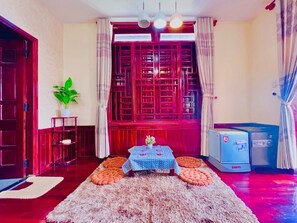 Family Quadruple Room, City View | Premium bedding, memory foam beds, desk, laptop workspace - Canary Homestay (Hue)