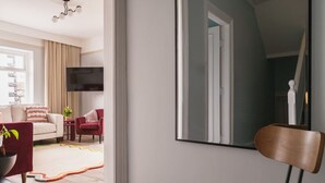 A modern living room with a sofa, armchairs, a coffee table, and a TV. - Crescent Retreat- Windermere centre (Windermere)