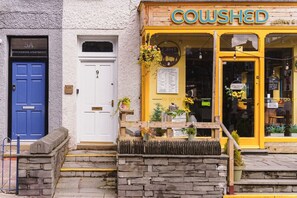 A storefront with a yellow sign reading "COWSHED coffee & tea." - Crescent Retreat- Windermere centre (Windermere)