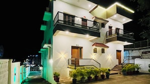 A two-story house with a balcony on the upper floor, a front door, and a staircase leading to the entrance. - SSS Golden Resorts (Tarangambadi)