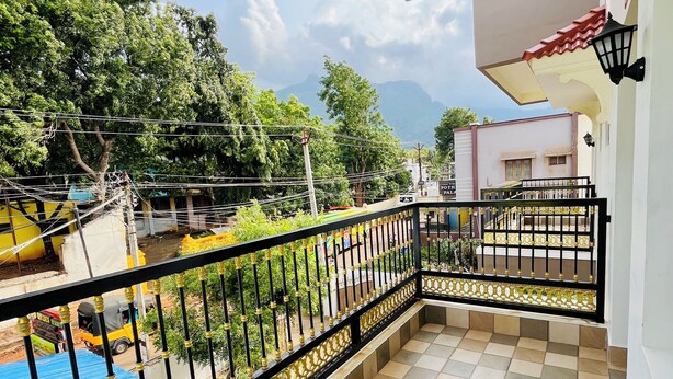 A balcony with a tiled floor and a metal railing. - SSS Golden Resorts (Tarangambadi)
