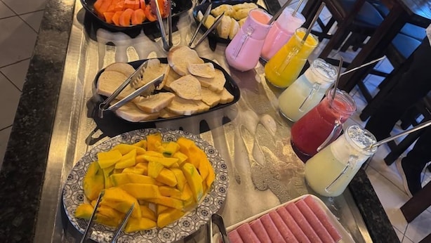 A buffet with various food items and drinks. - Hotel Prime Suítes (Cupira)