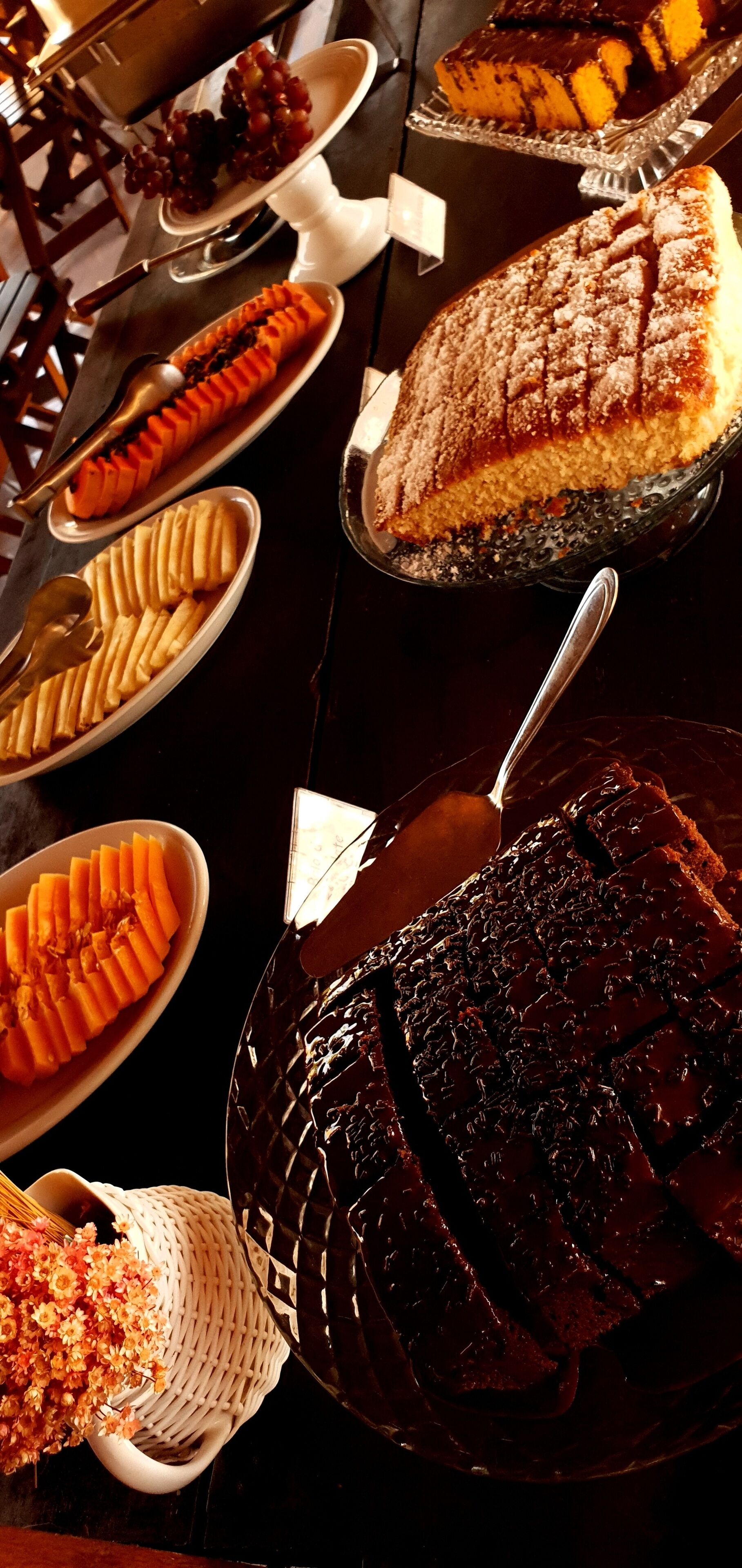 A buffet table with various desserts including cakes and pastries.