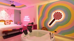 A modern bedroom with a bed, a desk, a chair, a bathtub, and a neon sign. - Orsom Stays Sassy Sector 53 (Gurugram)