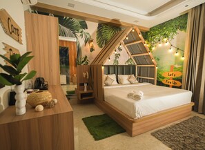 A bedroom with a wooden bed frame, a desk, and a wall mural. - Orsom Stays Sassy Sector 53 (Gurugram)