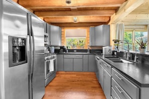 Enjoy cooking in this well-equipped kitchen with an oven, microwave, and sink.