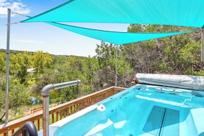 Relax by the pool, surrounded by lush greenery and a tranquil landscape.
