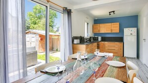 A modern kitchen with wooden cabinets, a microwave, and a refrigerator.