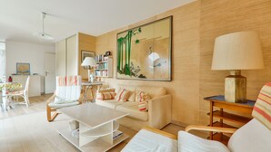 A modern living room with a sofa, coffee table, and a bookshelf. - Crouesty Harbor, flat with a pool for 4 (Arzon)