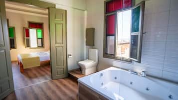 Deluxe Room, City View | Bathroom | Combined shower/tub, jetted tub, hair dryer, slippers