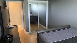 A bedroom with a bed, a TV, and a wardrobe. - Cozy condo, close to Northgate mall and Ring road Top Floor. (REGINA)