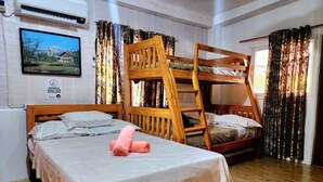 A room with two wooden bunk beds, a single bed, a wooden ladder, and a bed with pink towels. - 3 Bed House - Sleeps 20 - Pets - Pool - Garden (Aringay)