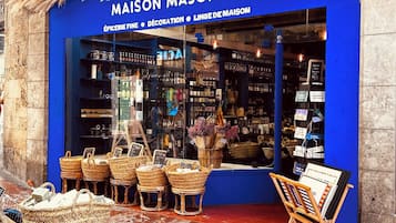 A storefront with a blue facade, wicker baskets, and a display of home decor items.