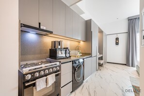 Fridge, microwave, oven, stovetop - Appealing Studio Apartment in MAG EYE 890, MBR City by Deluxe Holiday Homes (Dubai)