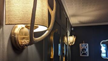 A wall-mounted lamp with a textured shade and a brass base.