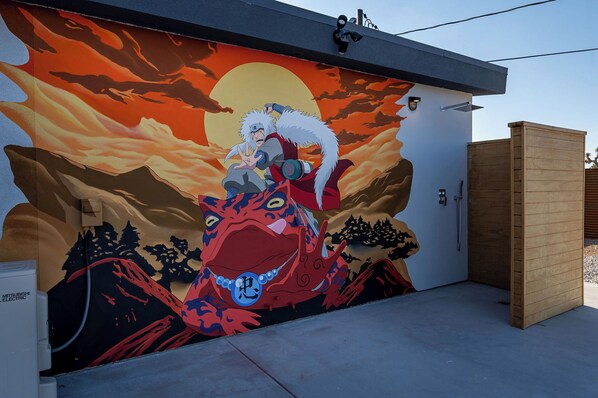 A mural of a character riding a dragon on a building wall.