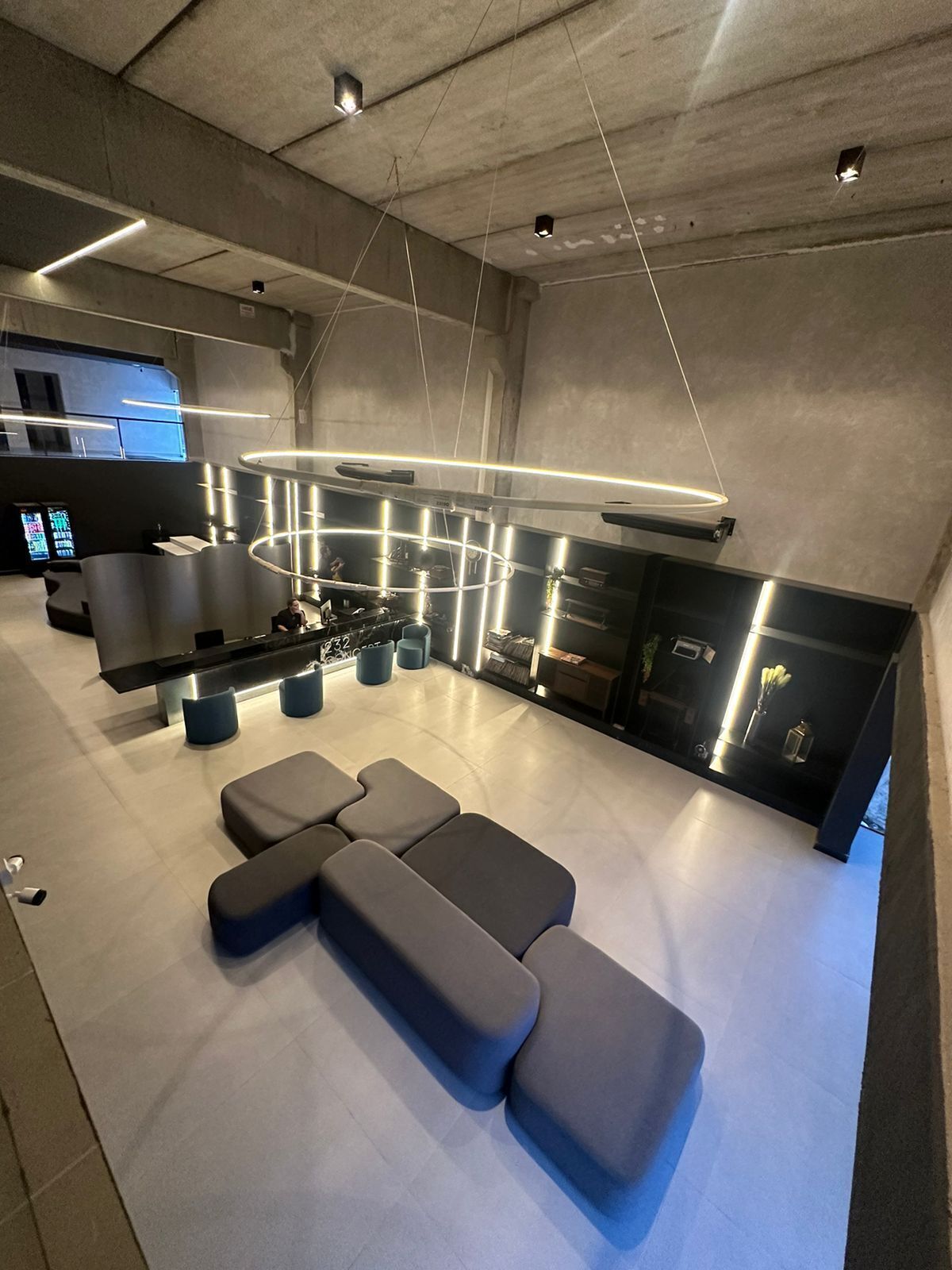 A modern kitchen with a central island, built-in appliances, and a seating area with benches.