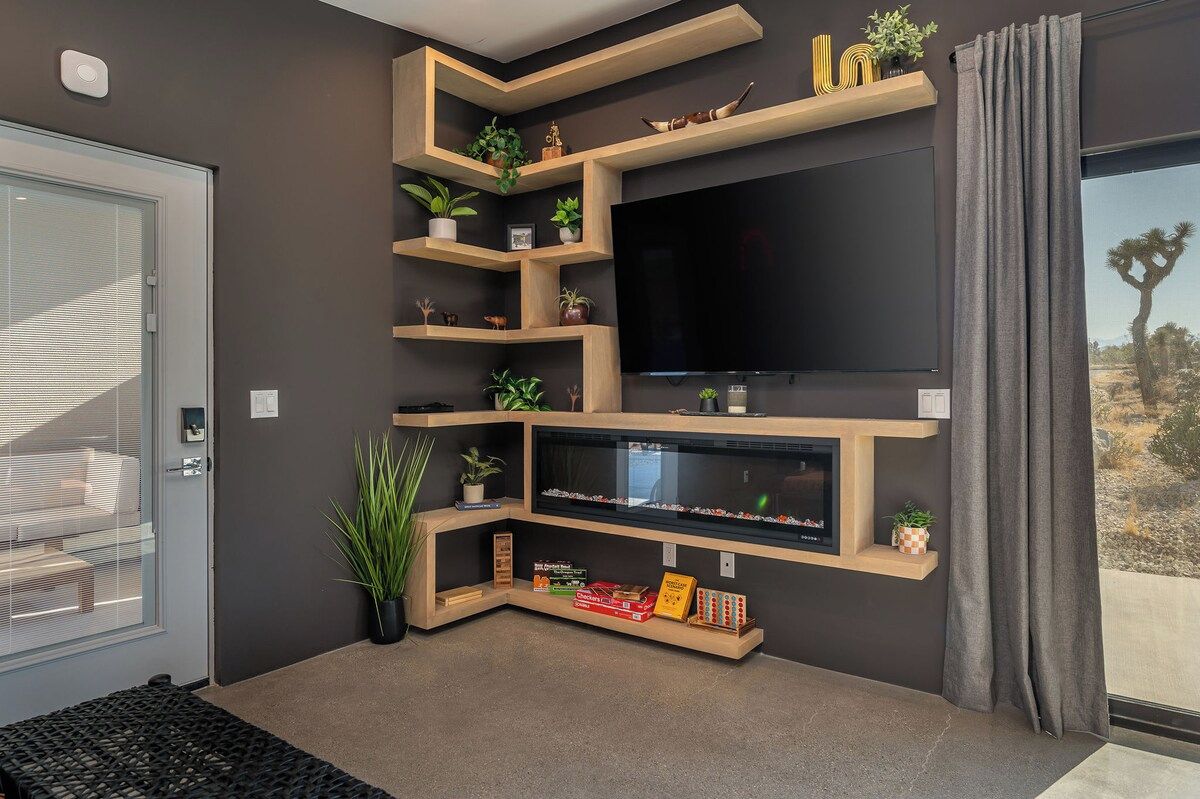 Entertainment wall with a large smart TV, electric fireplace