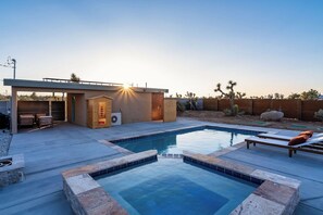 Saltwater pool and jacuzzi with sun loungers beside the sauna and tiny home
