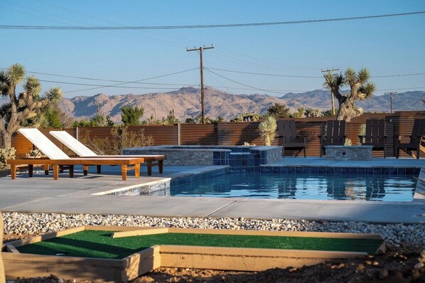 Saltwater pool and jacuzzi with sun loungers, mini golf and a fire pit