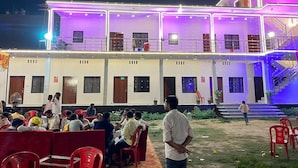 A building with multiple floors, outdoor seating areas, and a staircase leading to an upper level. - Madhur Kunj Guest House Pick and Drop (Faizabad)