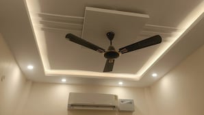 A ceiling with recessed lighting, a ceiling fan, and an air conditioning unit. - Madhur Kunj Guest House Pick and Drop (Faizabad)