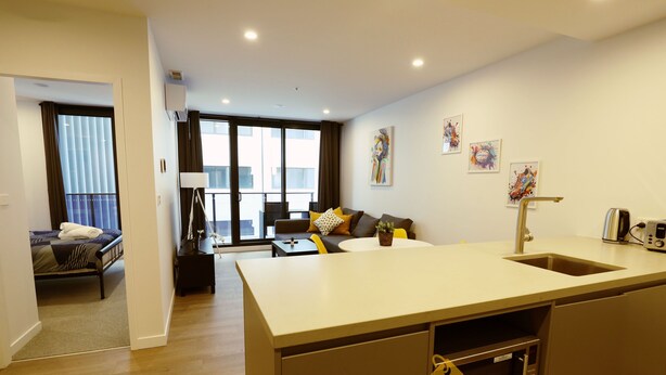 A modern apartment with a kitchen, dining area, and a living room. - Modern 1Bd Woden | Free Parking | Professionals (Phillip)