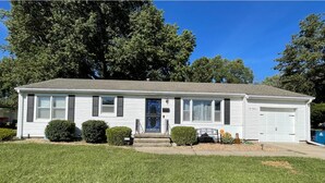 A single-story house with a front porch, a garage, and a well-maintained lawn. - Charming 3 Bedroom House away from it all but Close to everything (Odessa)