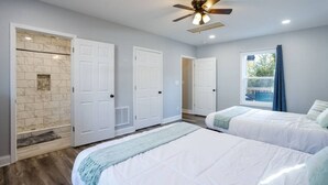 A bedroom with two beds, a ceiling fan, and a window with curtains. - Chic 2BR/2BA Near Dining & Shops (Winston-Salem)