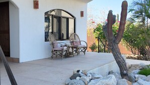 A patio with two wicker chairs, a table, and a cactus. - 10 Minute Walk to Pickleball and the Sea of Cortez (Los Barriles)