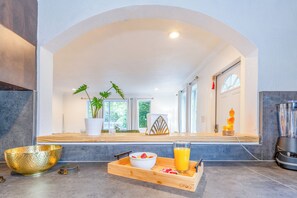 A modern kitchen with a breakfast tray, a golden bowl, and a blender. - Sleeps 10 | Private Pool | Jacuzzi | BBQ | Games | Games (Miami)