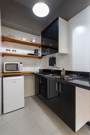 Microwave, stovetop, coffee/tea maker, cookware/dishes/utensils