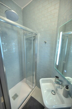 Shower, hair dryer, towels, toilet paper