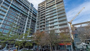 A modern high-rise building with multiple balconies and large windows. - Swainson on Hindmarsh (Adelaide)