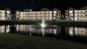 A multi-story hotel with a central courtyard featuring a fountain. - King Condo In Panama City Beach Resort Amenities Hot Tub Downtown Pier Park (Panama City)