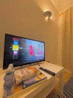 Comfort Apartment, Garden View | Living area | 24-inch TV with digital channels, Netflix, streaming services