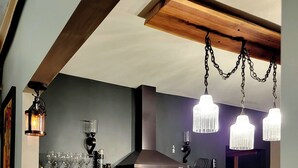 Una cocina moderna con encimeras de madera, estufa de acero inoxidable y luces colgantes.