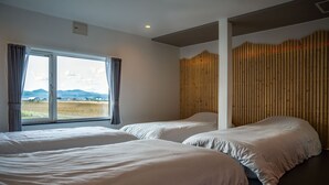 A hotel room with two beds, a large window with curtains, and a wooden slat wall. - THE FURANO HIBIKI (Furano)