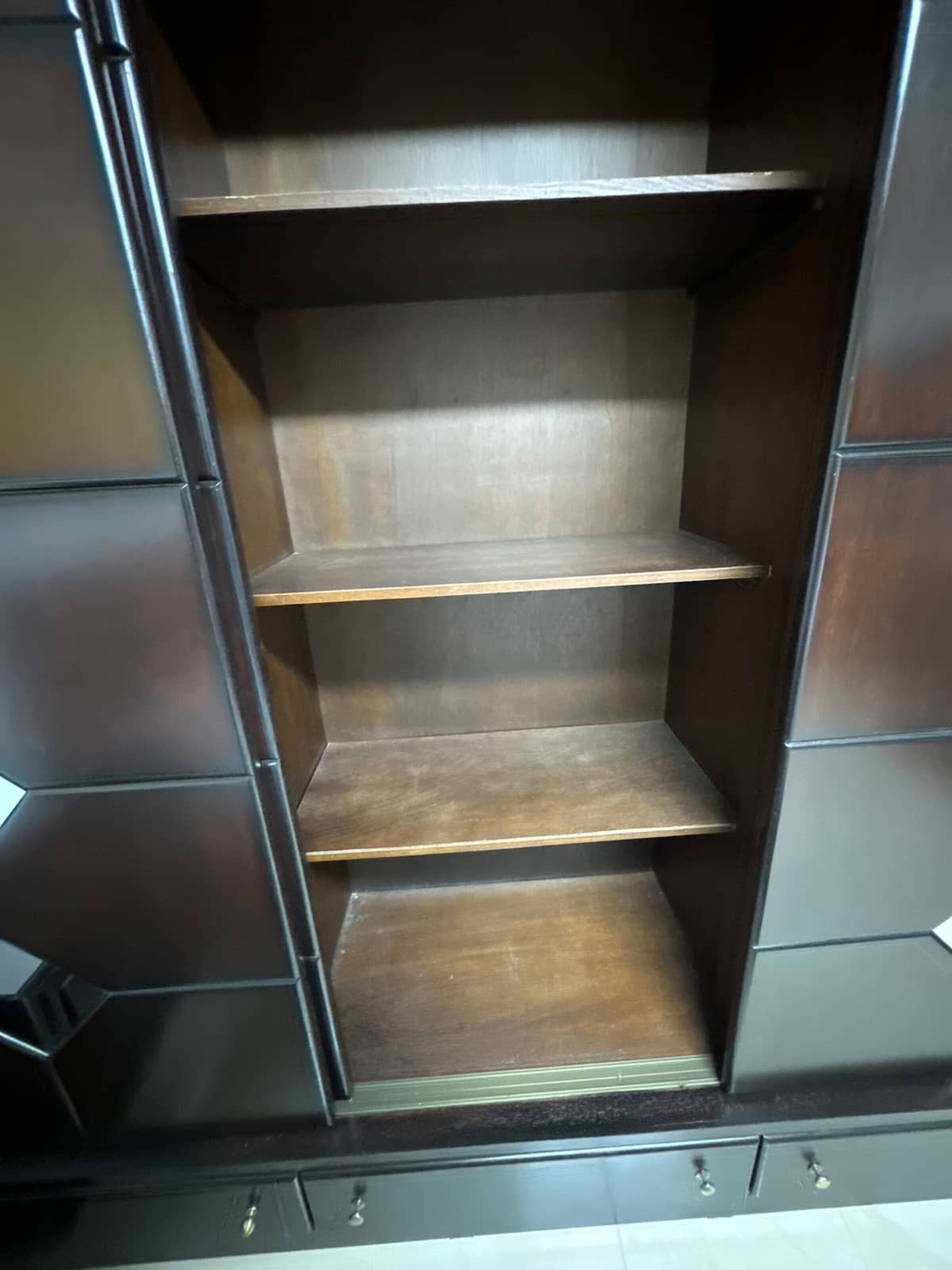 A wardrobe with three shelves and a hanging rod.