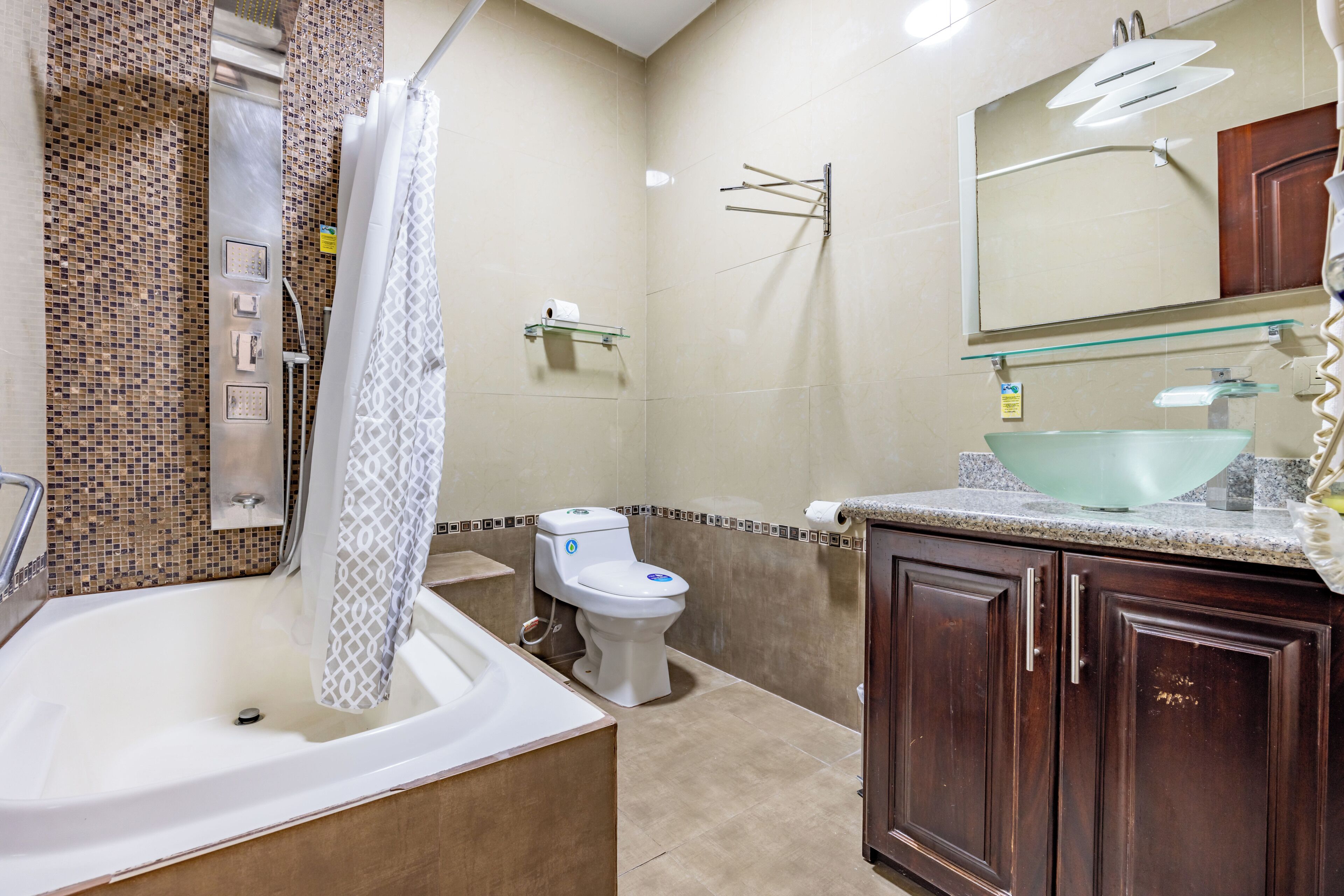 A bathroom with a bathtub, toilet, and sink.